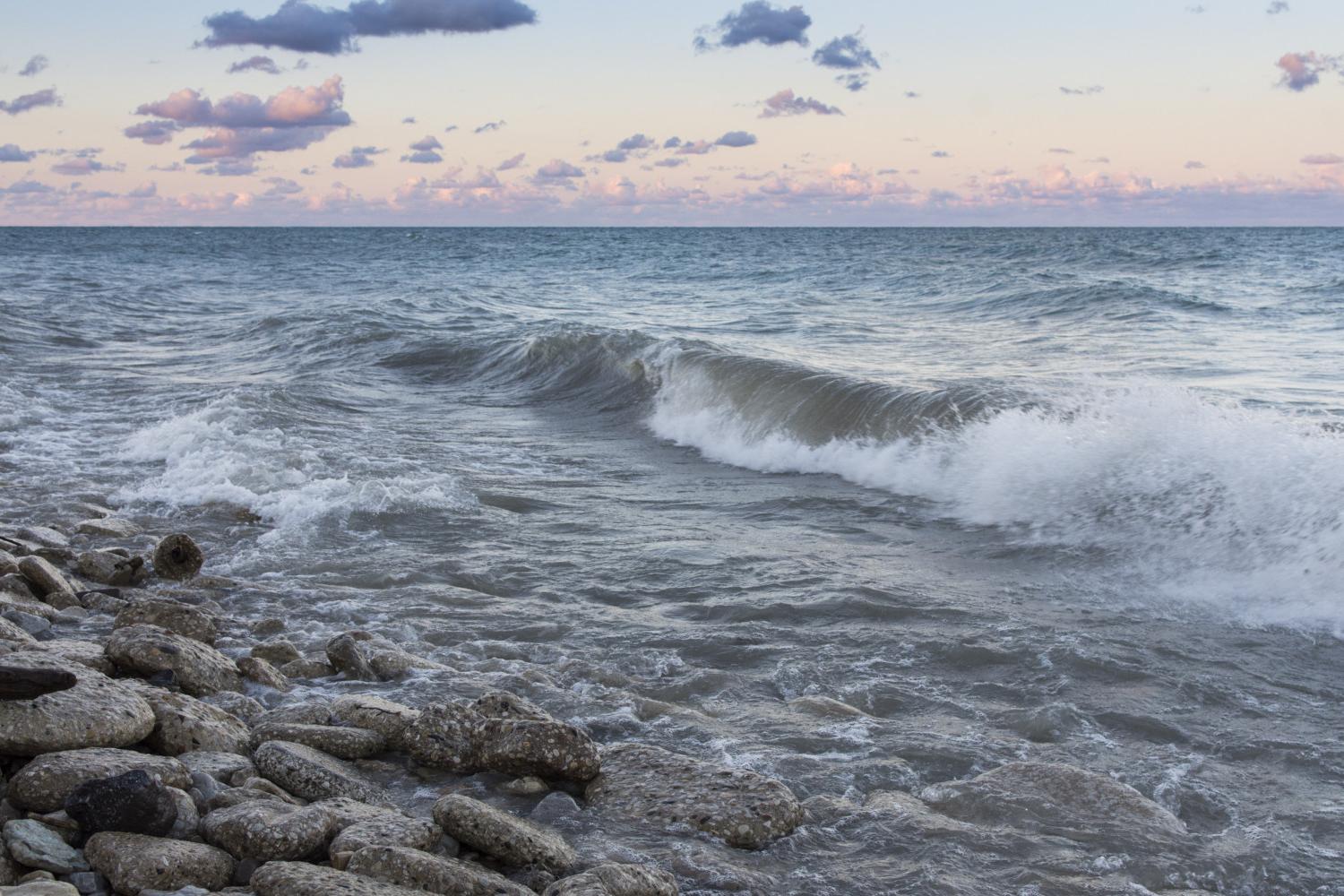 The sun rises over Lake Michigan on the <a href='http://72am.dhwee.com'>BETVLCTOR伟德登录</a> campus.